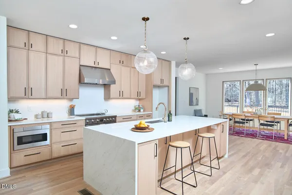 a kitchen with granite countertop a sink and a stove