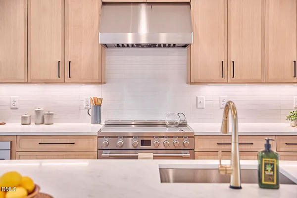 a kitchen with a sink a counter and a view of living room