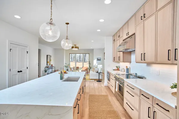 a living room with furniture a lamp and a chandelier