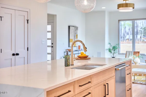 a dining room with furniture a rug a rug and a chandelier