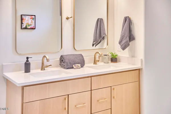 a bathroom with a double vanity sink and a mirror