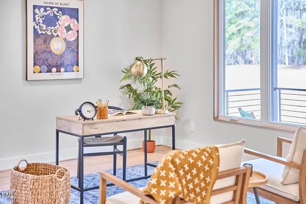 a view of empty room with wooden floor
