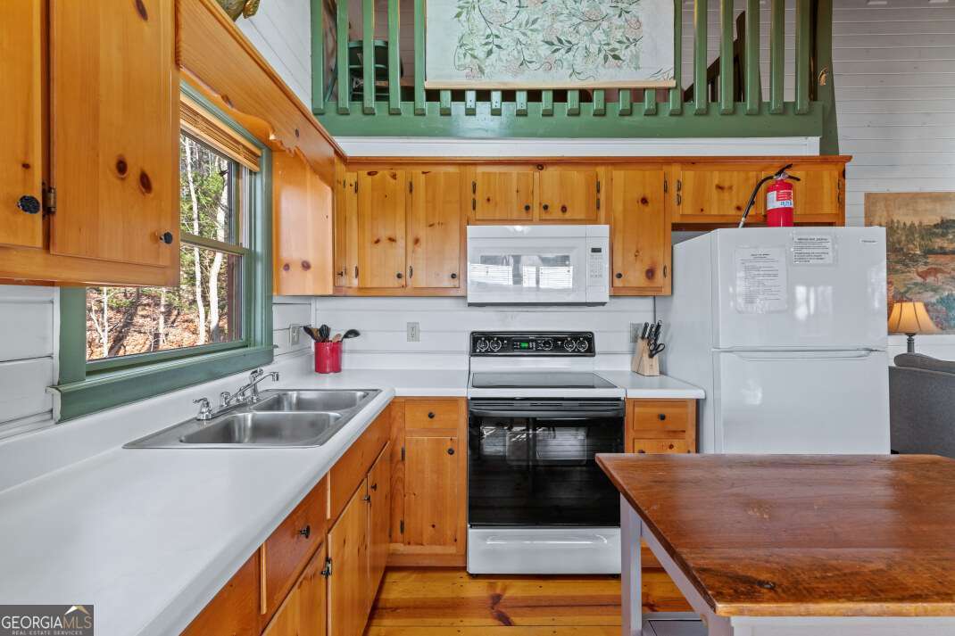 100 Smith Hill Road Blue Ridge, GA 30513 - Photo 18 of 66 a kitchen with stainless steel appliances granite countertop a sink and a stove