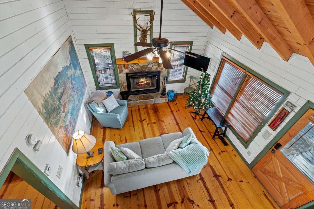 100 Smith Hill Road Blue Ridge, GA 30513 - Photo 24 of 66 a living room with furniture a fireplace and a flat screen tv