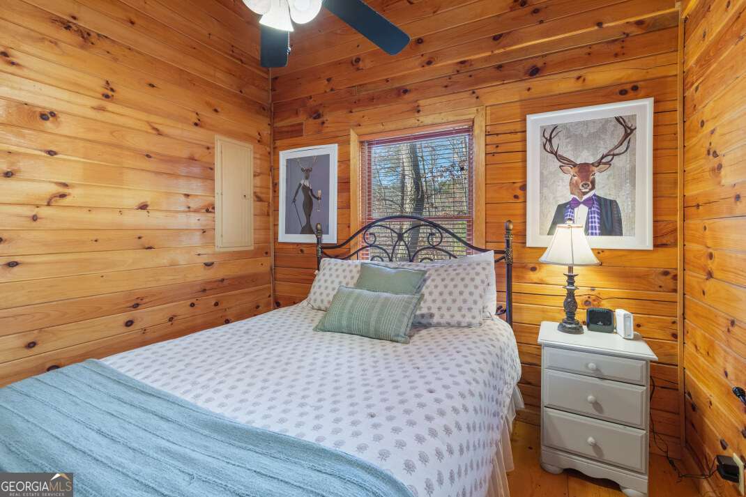 100 Smith Hill Road Blue Ridge, GA 30513 - Photo 28 of 66 a bedroom with a bed and wooden floor