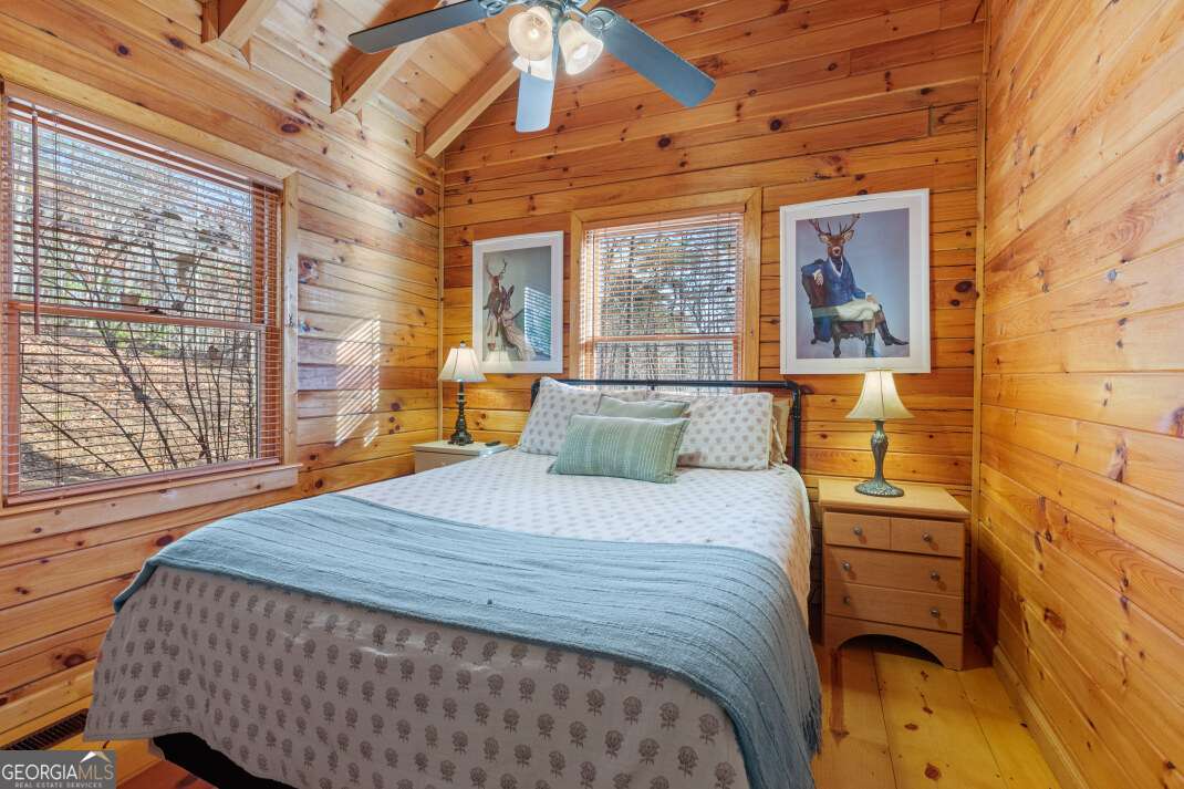 100 Smith Hill Road Blue Ridge, GA 30513 - Photo 30 of 66 a bedroom with a bed and wooden floor