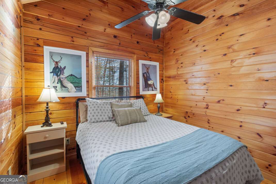 100 Smith Hill Road Blue Ridge, GA 30513 - Photo 31 of 66 a bedroom with a bed and wooden floor