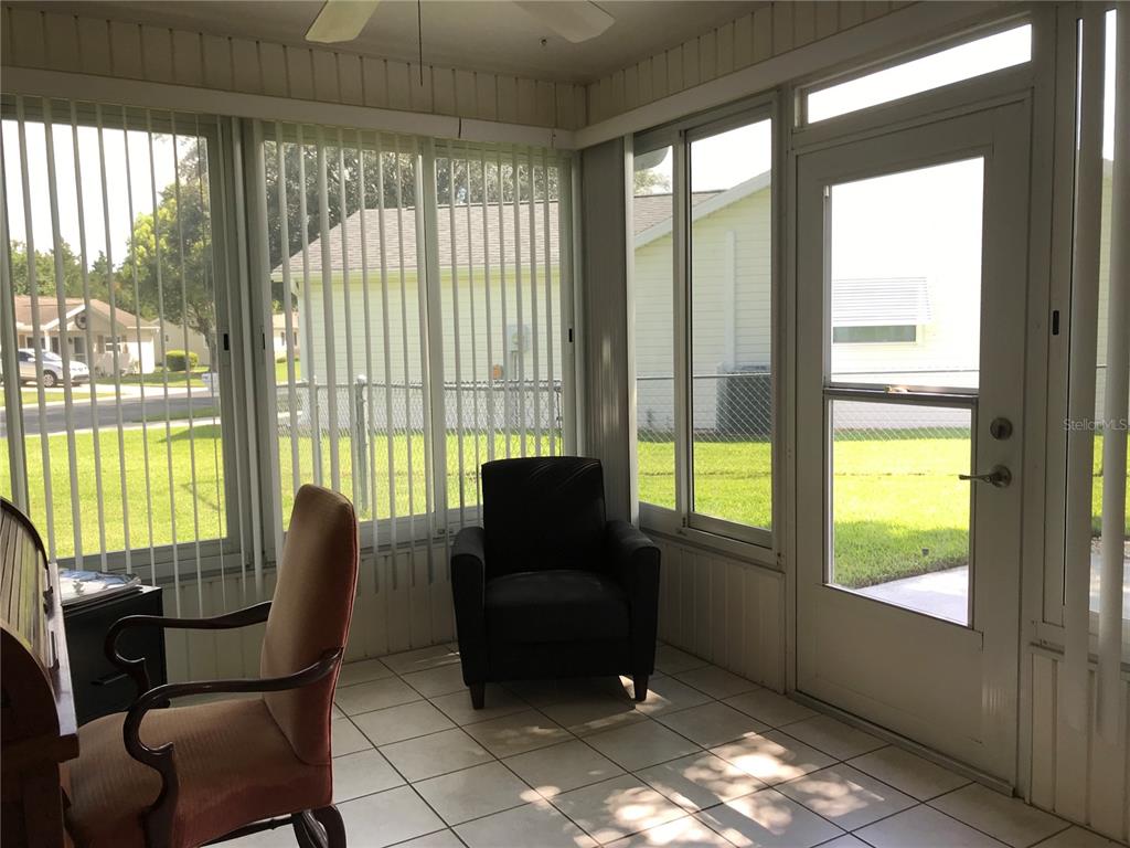11879 Southwest 137th Loop Dunnellon, FL 34432 - Photo 28 of 37 a living room with furniture and a floor to ceiling window