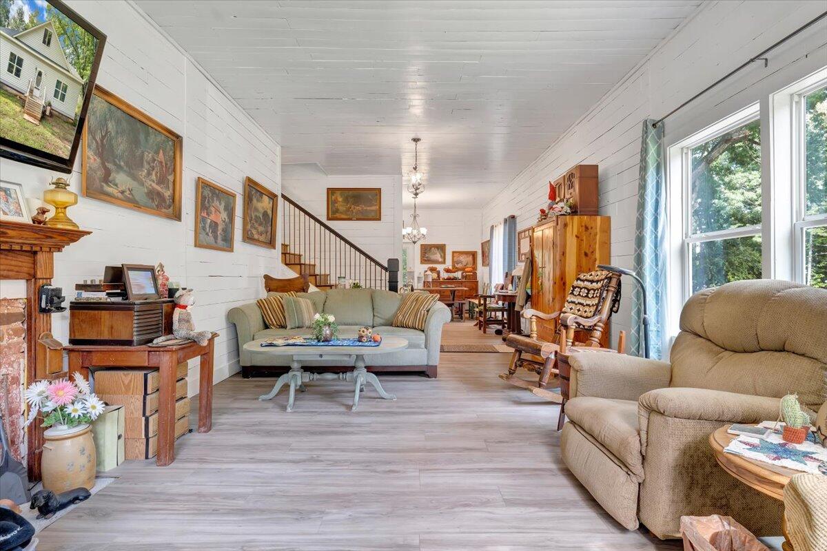 568 Moores Mill Road Ridgeway, VA 24148 - Photo 7 of 51 a living room with furniture large window and wooden floor