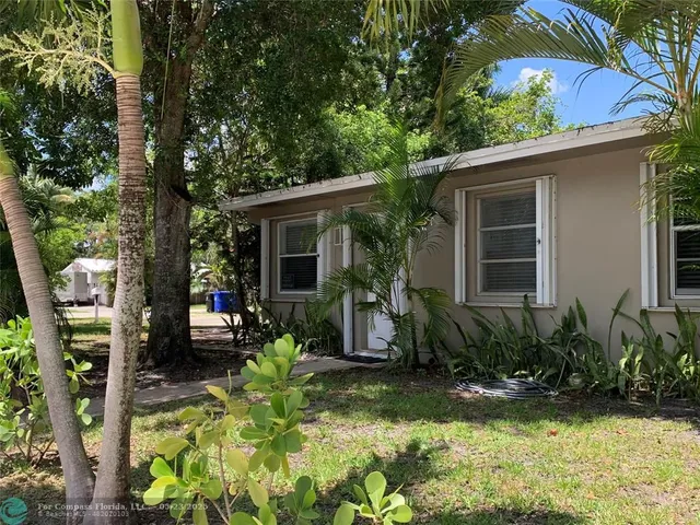 front view of a house with a tree