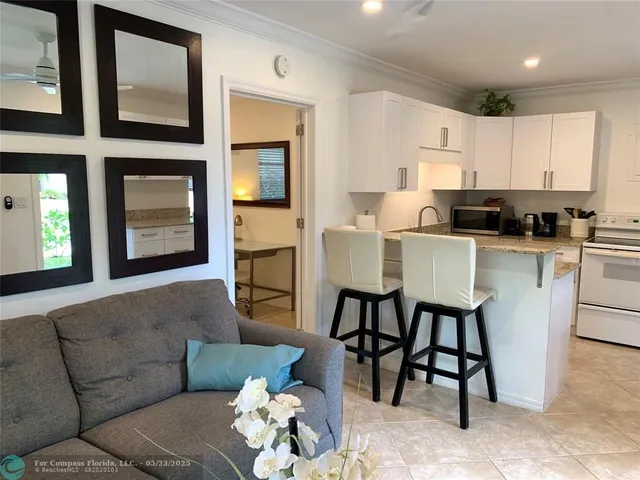a kitchen with a granite countertop sink and white cabinets