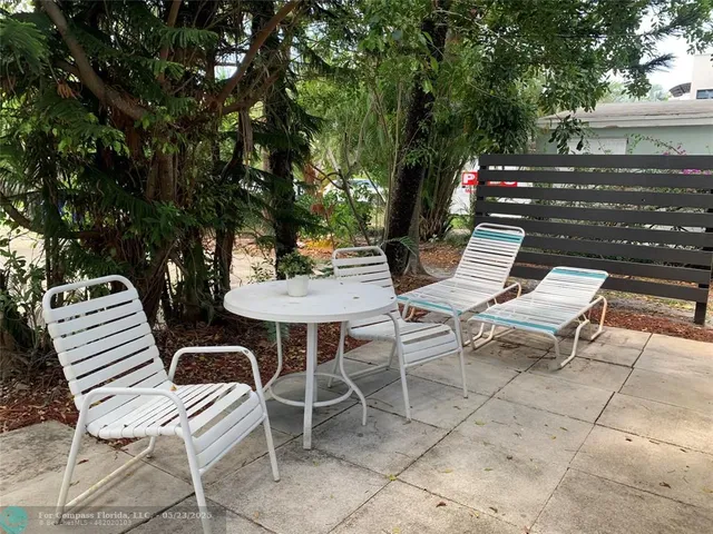 a kitchen with stainless steel appliances granite countertop a sink a stove a microwave a refrigerator and cabinets