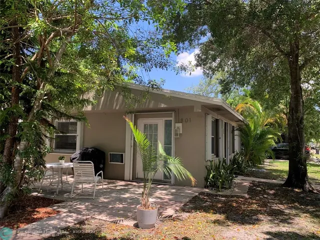 a kitchen with granite countertop a sink stove and white cabinets