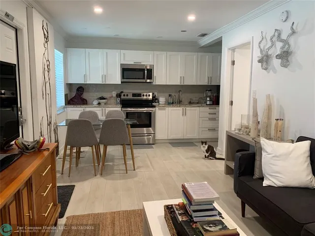 a view of house with yard and tree in front of it