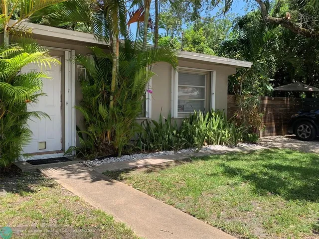 a bedroom with a bed and a night stand