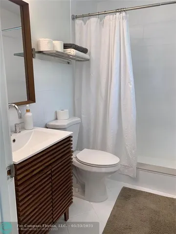 a view of a patio with table and chairs potted plants and large tree