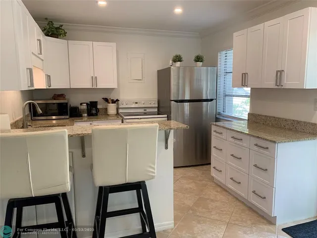 a bedroom with two beds and a lamp