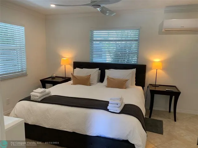 a bedroom with a bed and window