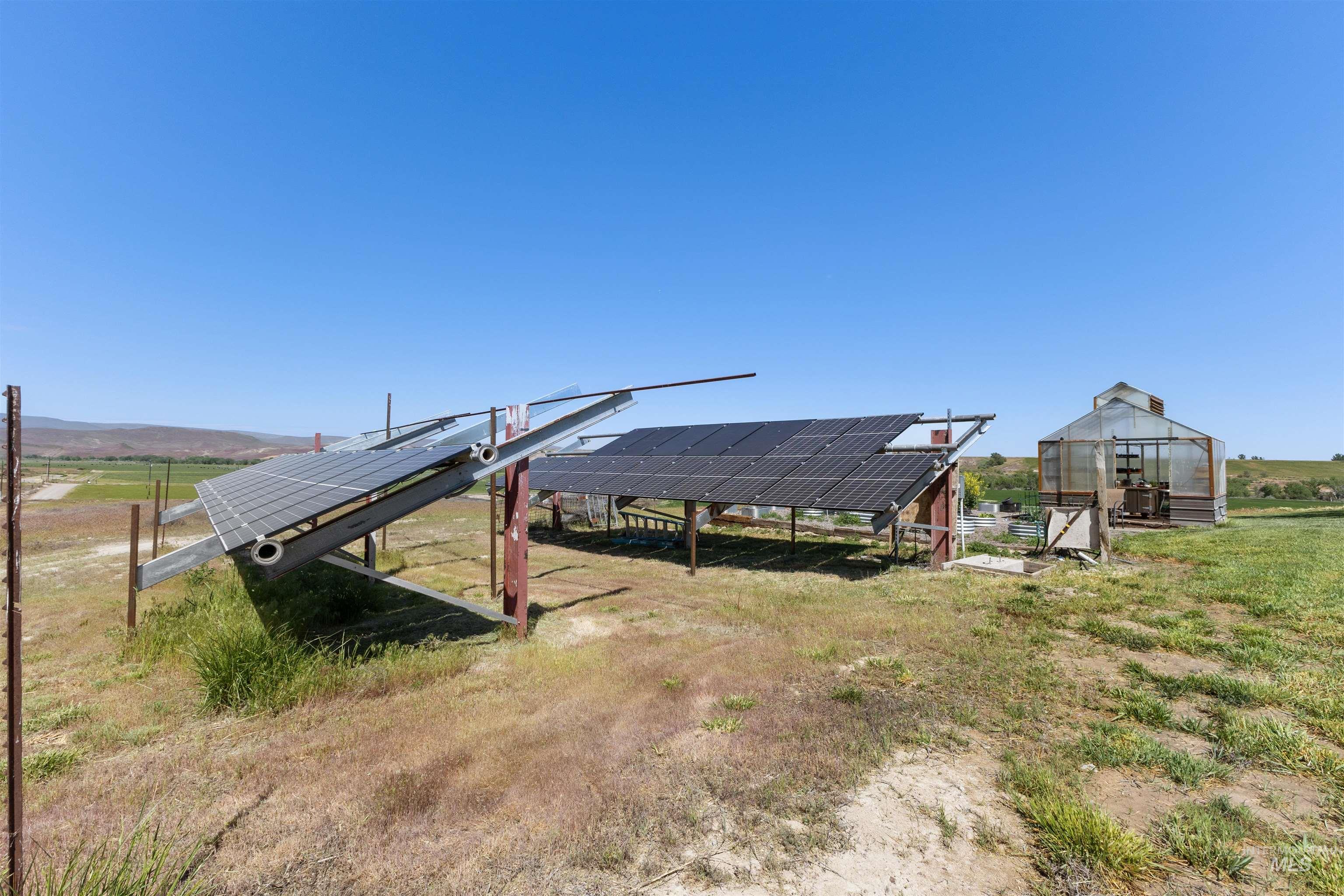 1030 Desert Glen Road Adrian, OR 97901 - Photo 47 of 47 Ground-mounted solar panels alongside a greenhouse structure