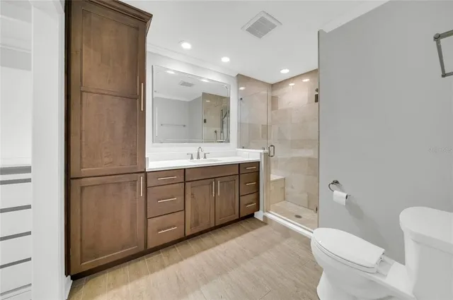 a bathroom with a double vanity sink toilet mirror and bathtub