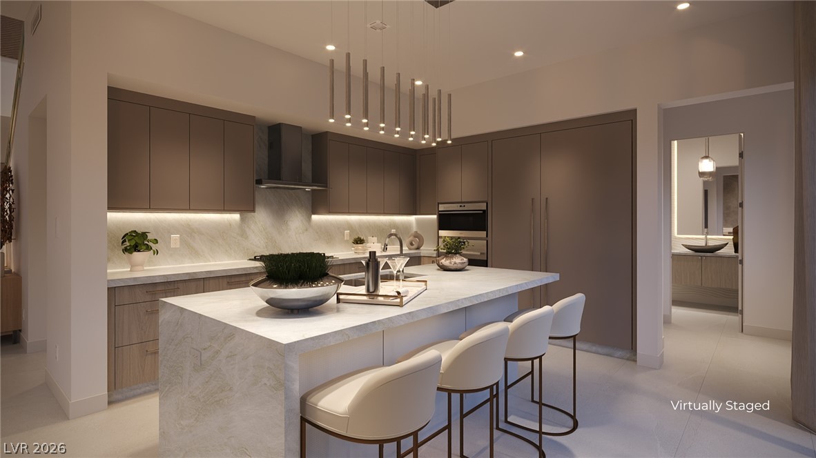 505 Overlook Rim Drive Henderson, NV 89012 - Photo 8 of 22 Culinary delights await in this modern kitchen with sleek cabinetry and a generously sized island.