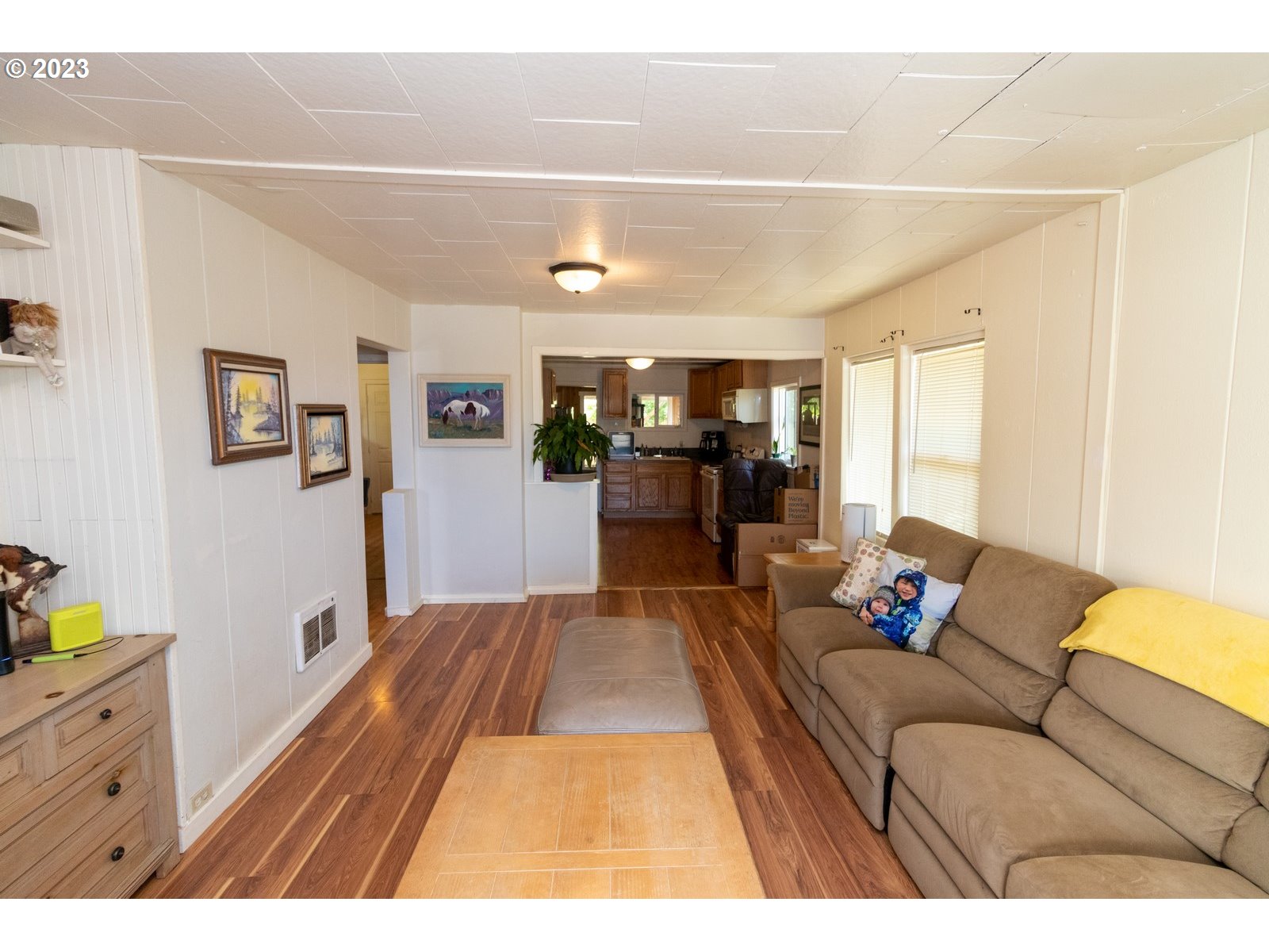 242 Elm Avenue Reedsport, OR 97467 - Photo 7 of 31 a living room with furniture and a dining table with wooden floor