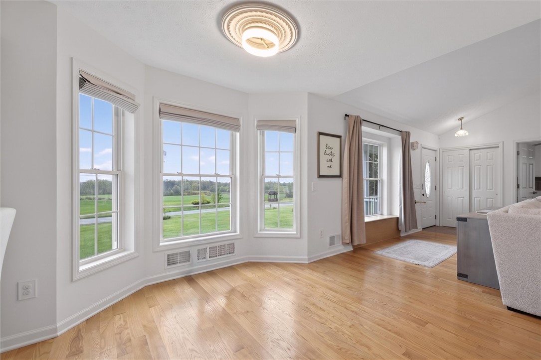 663 Hosmer Road Churchville, NY 14428 - Photo 23 of 42 Virtual staged photo, minus chair, plenty of space for a dining table.