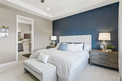 a bedroom with a bed and a couch