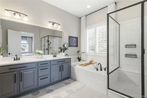 a spacious bathroom with a tub sink shower and mirror
