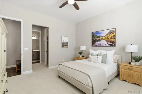 a bedroom with a bed and a painting on the wall