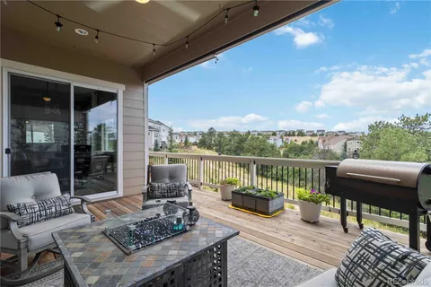 a roof deck with a table and chairs