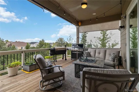 a view of a balcony with wooden floor and fence