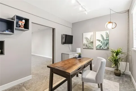 a large bed sitting in a room next to a lamp