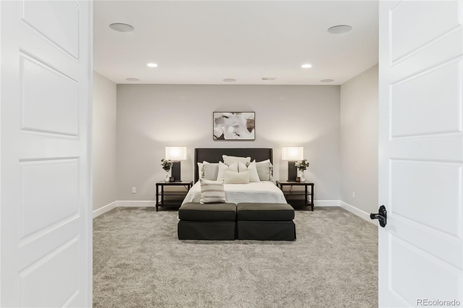 3117 Keepsake Way Castle Rock, CO 80109 - Photo 37 of 50 a large bed sitting in a room next to a lamp