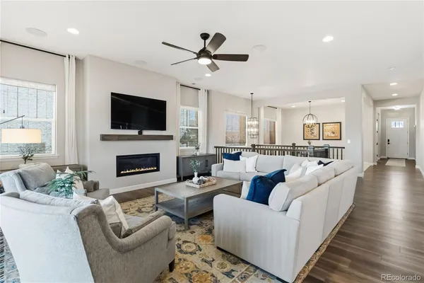 a living room with furniture a fireplace and a flat screen tv