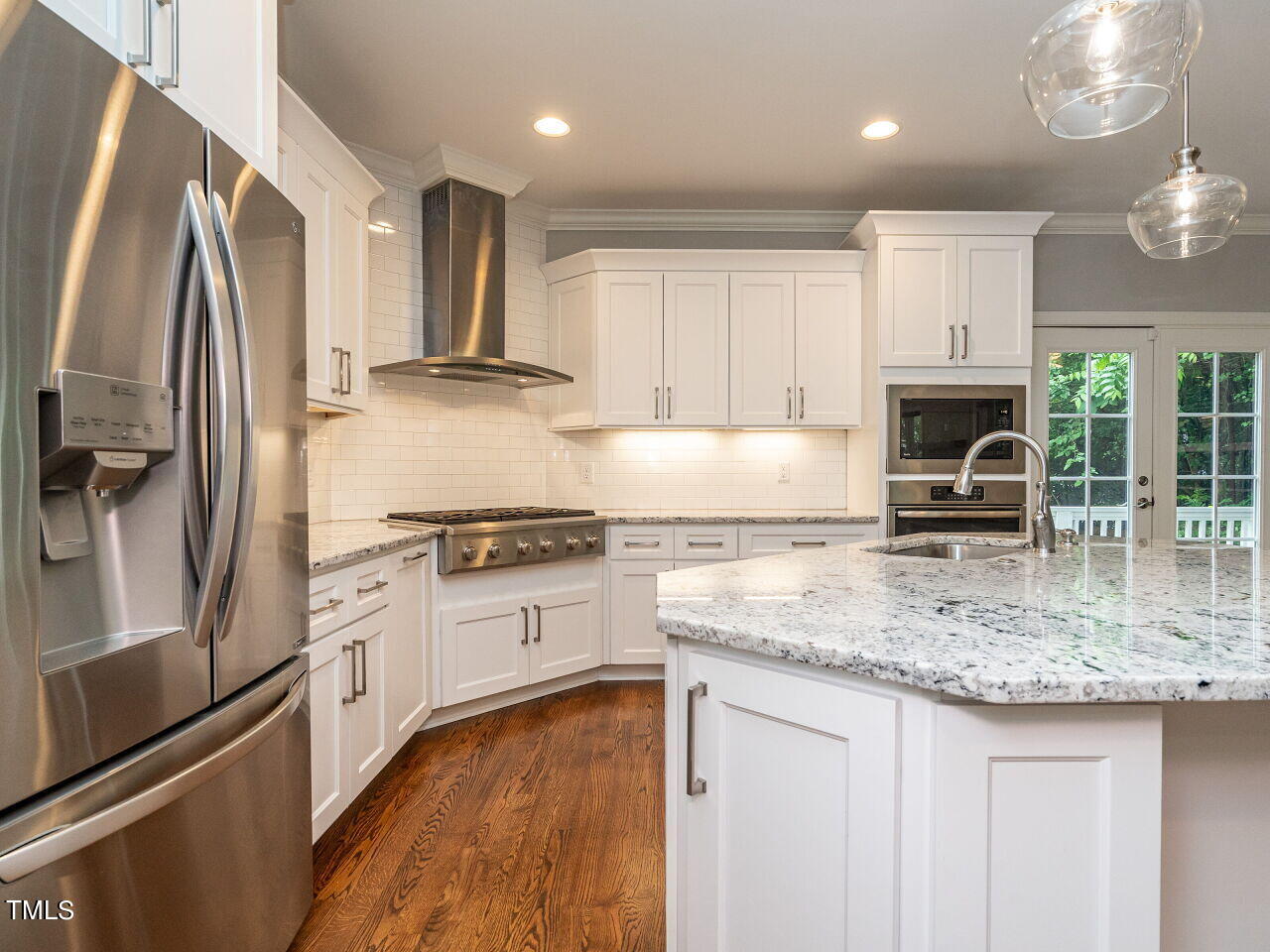 1506 East Jones Street Raleigh, NC 27610 - Photo 13 of 35 a kitchen with stainless steel appliances granite countertop a stove refrigerator and cabinets