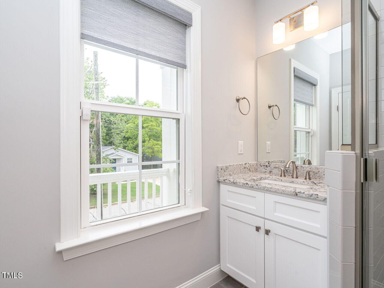 1506 East Jones Street Raleigh, NC 27610 - Photo 21 of 35 a bathroom with a window sink and mirror