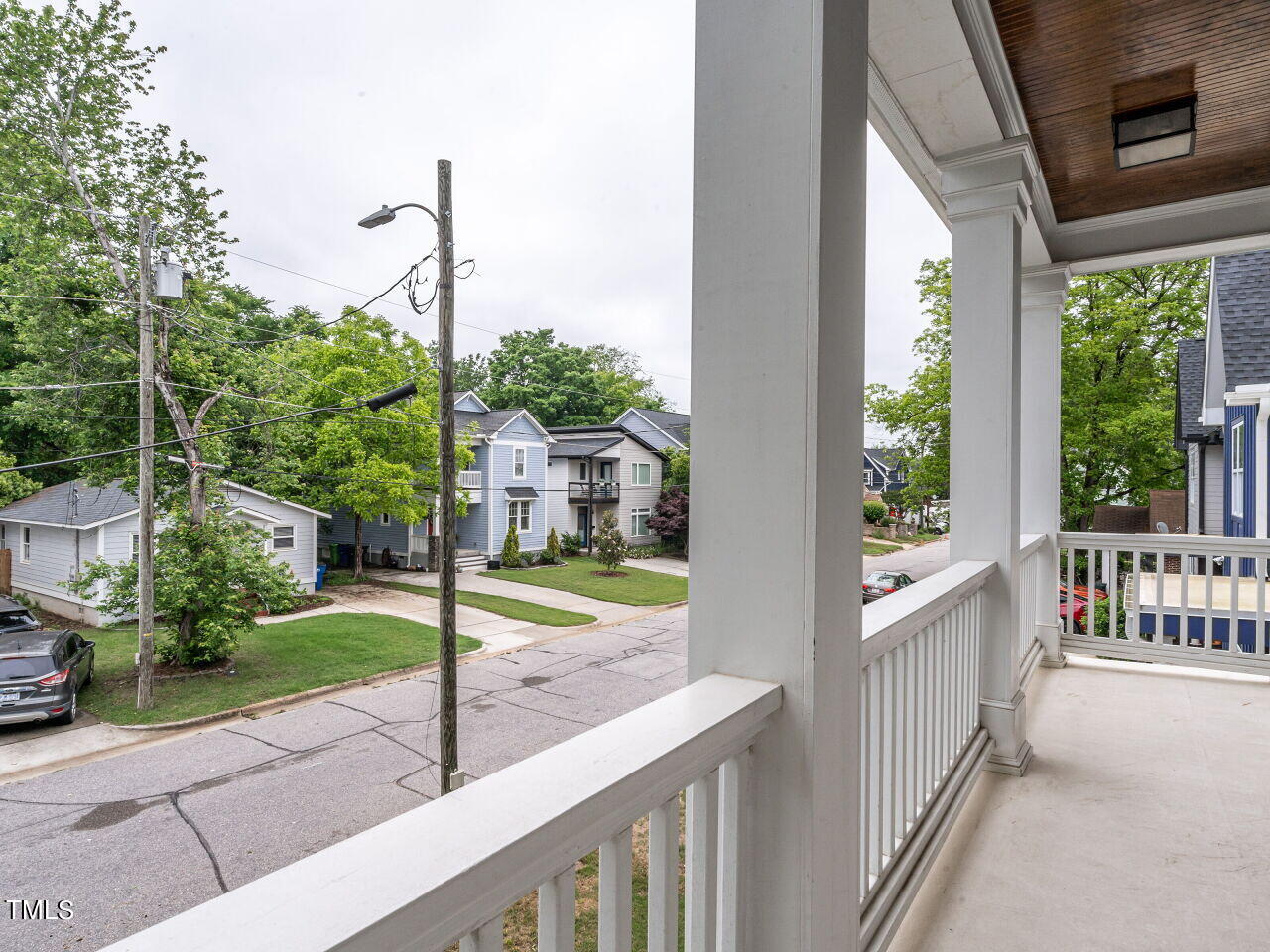 1506 East Jones Street Raleigh, NC 27610 - Photo 22 of 35 a view of a house with a floor to ceiling window and wooden fence