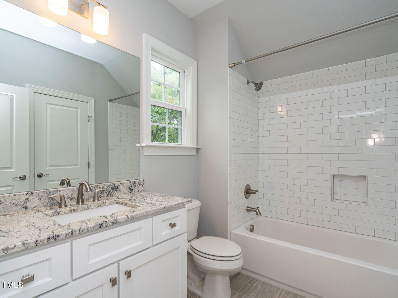 1506 East Jones Street Raleigh, NC 27610 - Photo 29 of 35 a bathroom with a granite countertop sink a toilet and bathtub