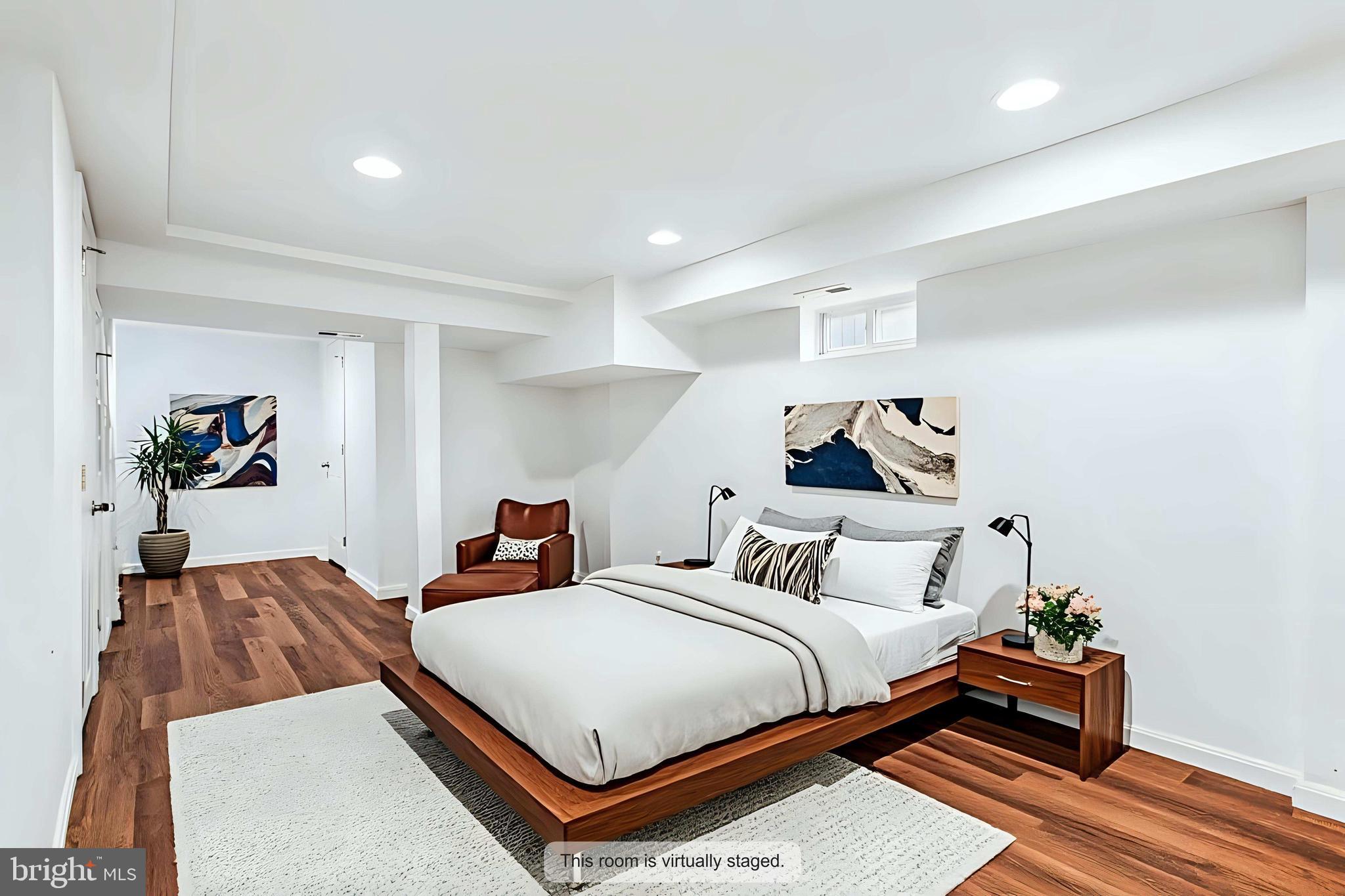 836 Division Avenue Northeast Washington, DC 20019 - Photo 22 of 36 a bedroom with a bed and wooden floor