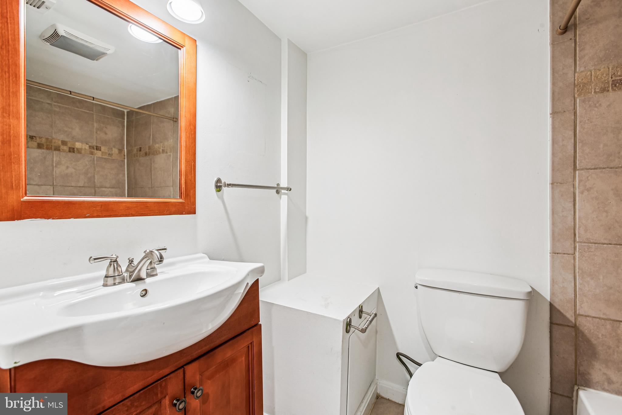 836 Division Avenue Northeast Washington, DC 20019 - Photo 27 of 36 a white toilet sitting next to a bathroom sink
