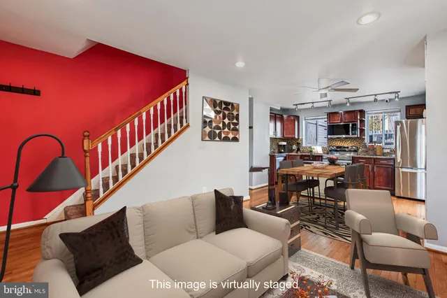 a living room with furniture kitchen view and a window