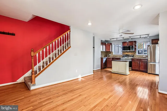 a view of kitchen with microwave and wooden floor