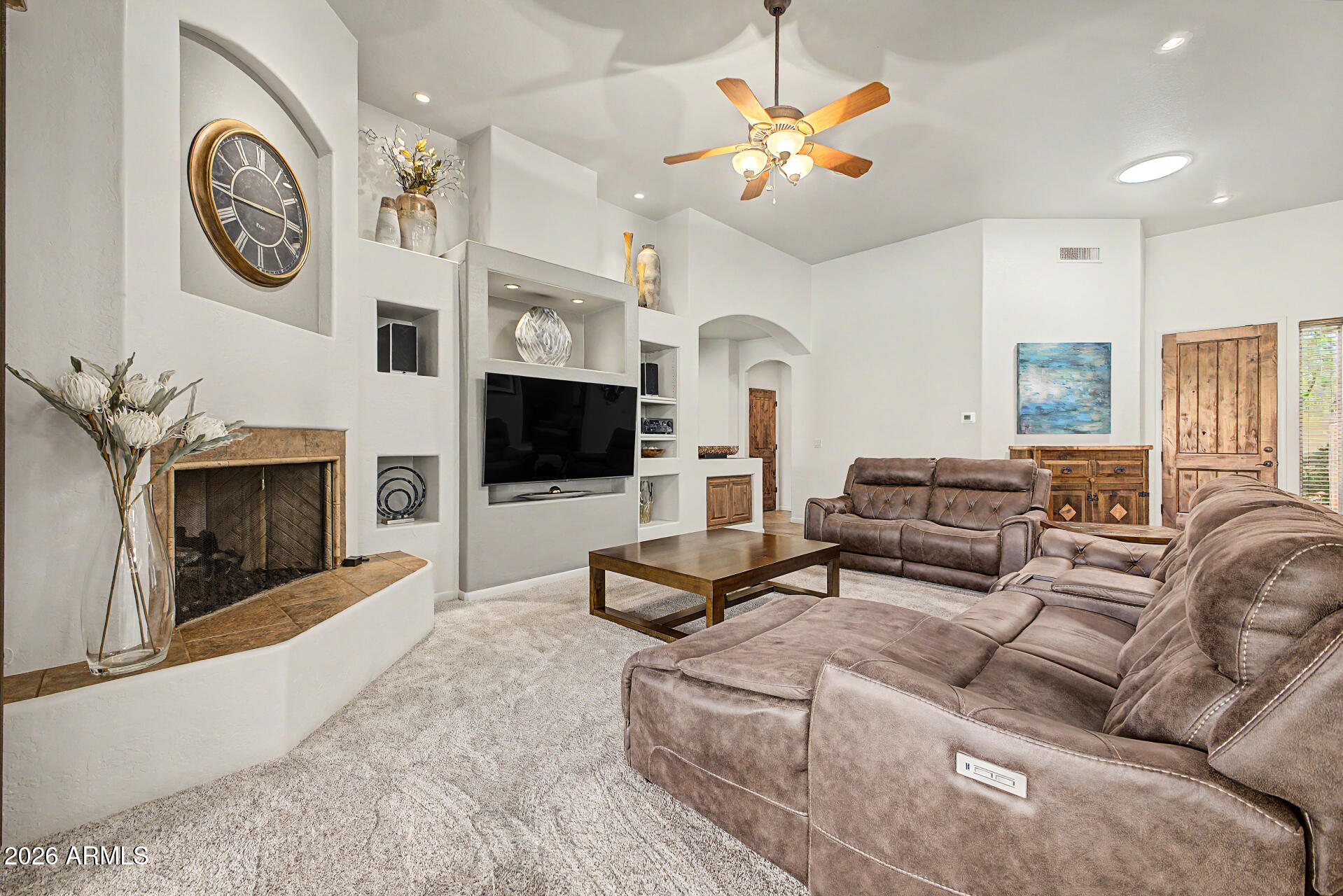 27909 North Quail Spring Road Rio Verde, AZ 85263 - Photo 6 of 52 a living room with furniture a flat screen tv and a fireplace