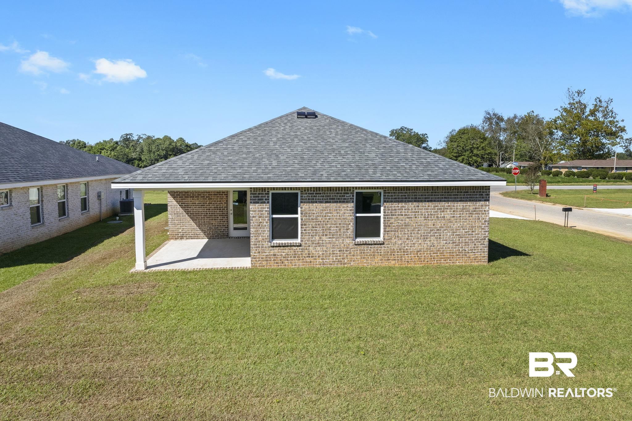 16014 Alabama Avenue Silverhill, AL 36576 - Photo 40 of 50 Rear view of property featuring cooling unit, a lawn, and a patio area