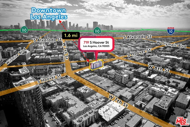 a sign board with buildings in the background