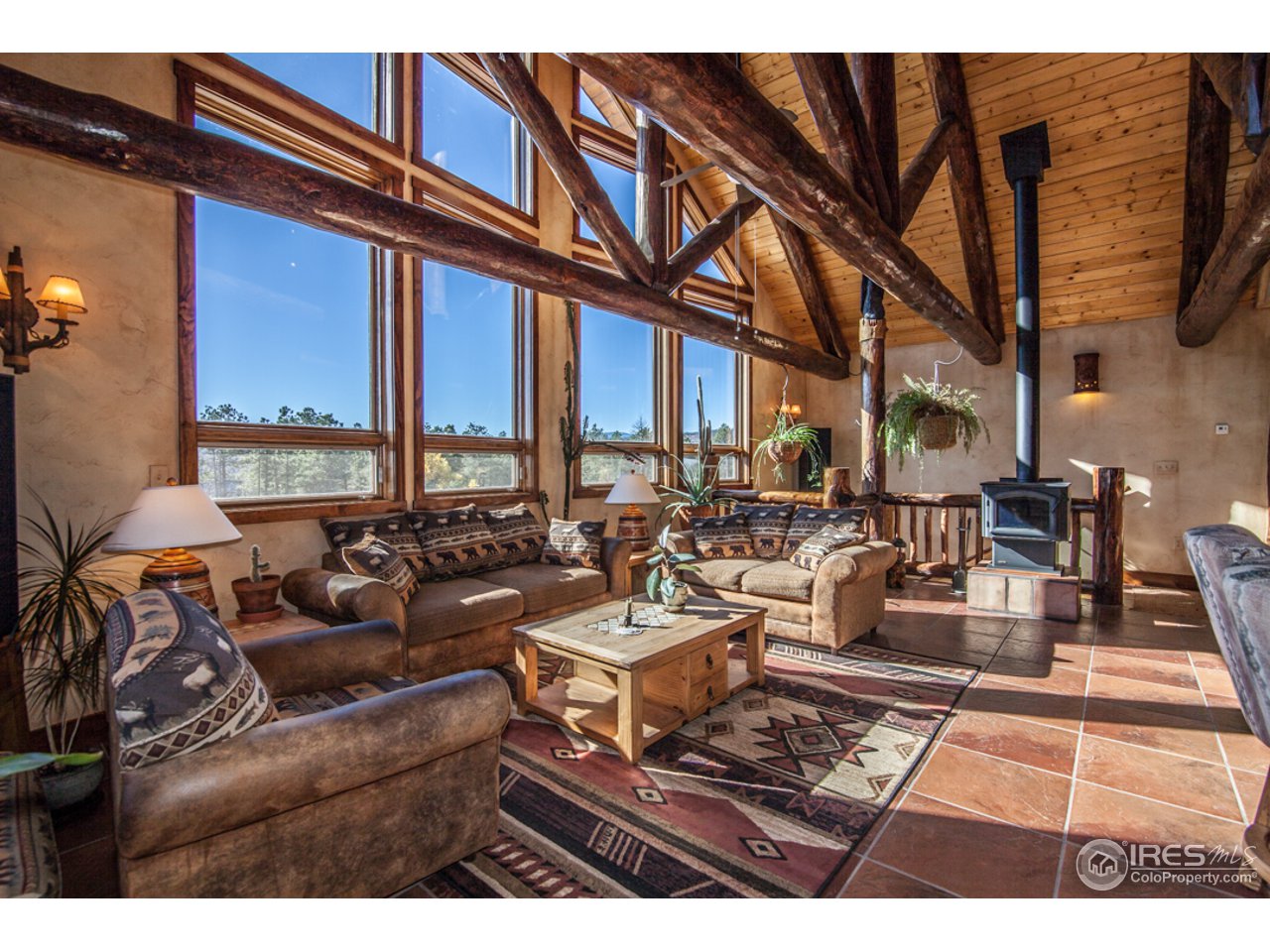3375 Davis Ranch Road Bellvue, CO 80512 - Photo 3 of 24 a living room with furniture a large window and a rug