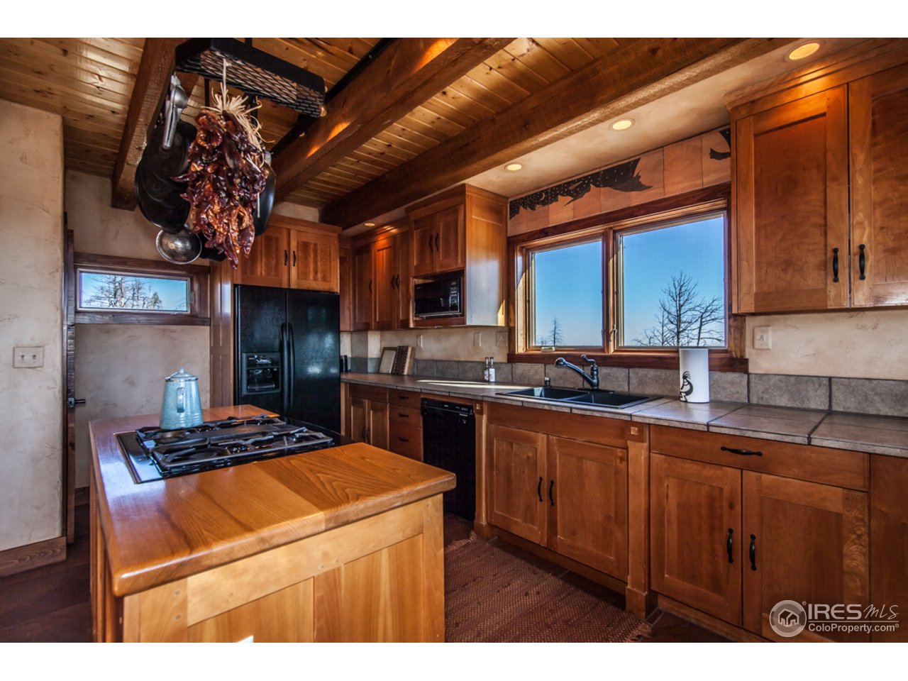 3375 Davis Ranch Road Bellvue, CO 80512 - Photo 6 of 24 a kitchen with a sink a stove and cabinets