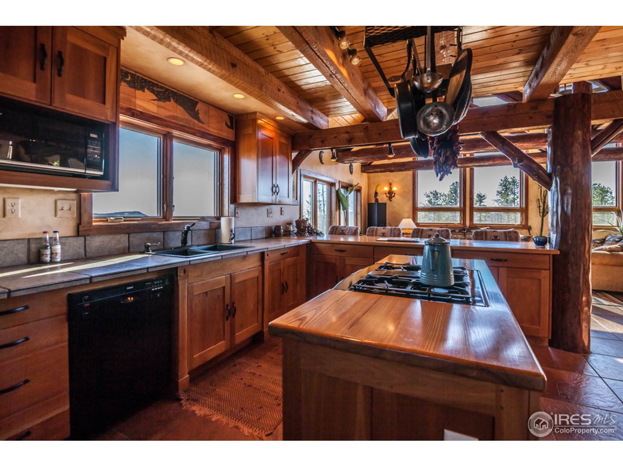 3375 Davis Ranch Road Bellvue, CO 80512 - Photo 7 of 24 a kitchen with a sink a stove and cabinets