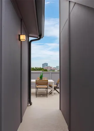 a view of a balcony with table and chairs